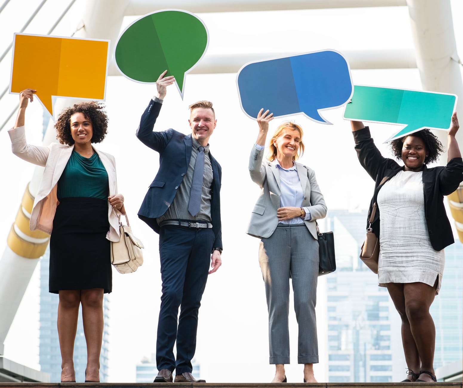 four person holding app banners